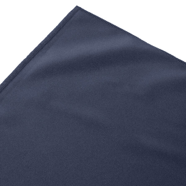 A folded navy blue Snap Drape table skirt with shirred pleats.