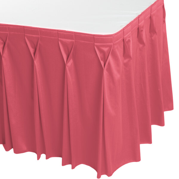 A dusty rose Snap Drape table skirt with pleated edges.