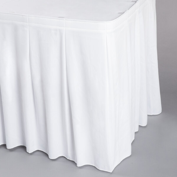 A white Snap Drape table skirt on a white table.