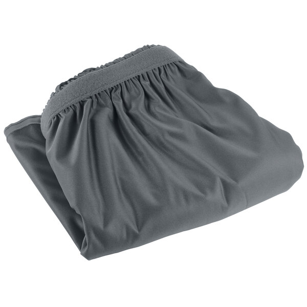 A Snap Drape slate blue shirred pleat table skirt with a folded edge on a table.