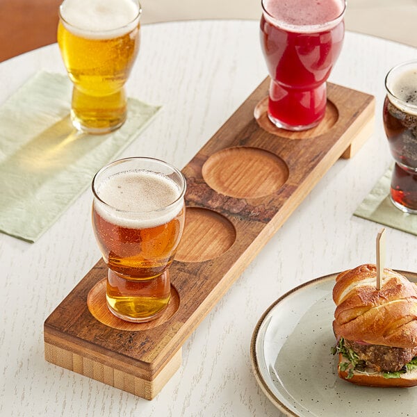 An American Metalcraft carbonized bamboo flight board with a glass of beer on it.