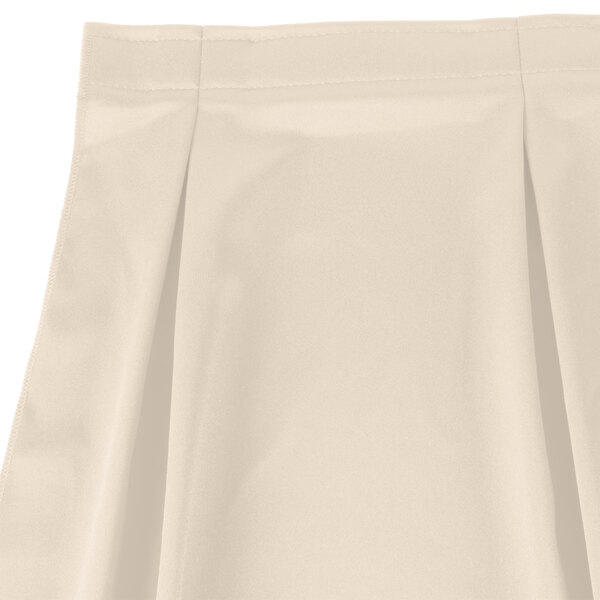 A white Snap Drape table skirt with pleats on it.