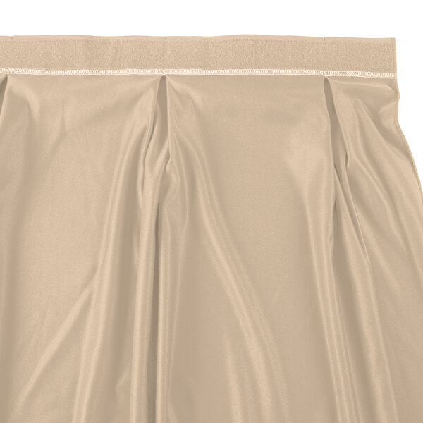 A cream Snap Drape table skirt with a pleated bow tie hem.
