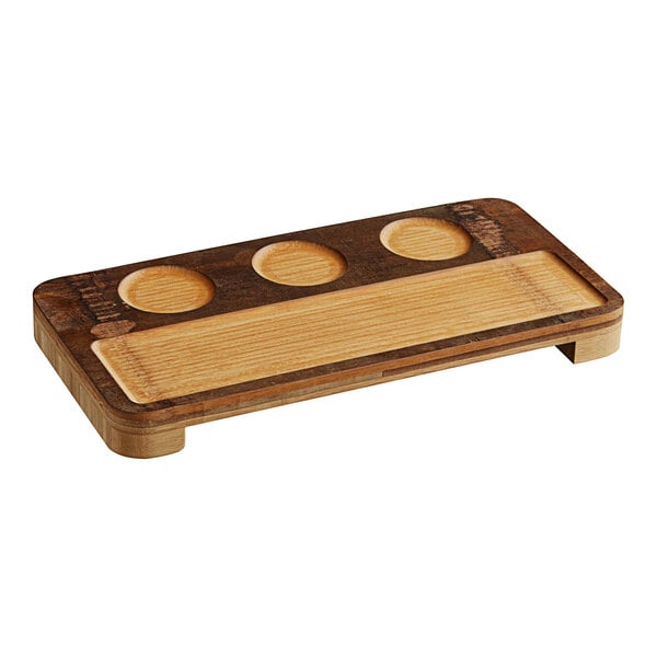 An American Metalcraft carbonized bamboo board with three holes in it on a table in a bar.