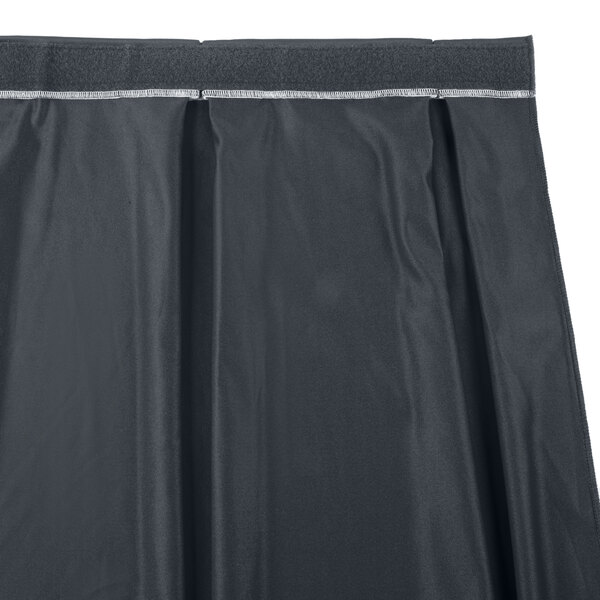 A black box pleat table skirt with white trim on a white background.