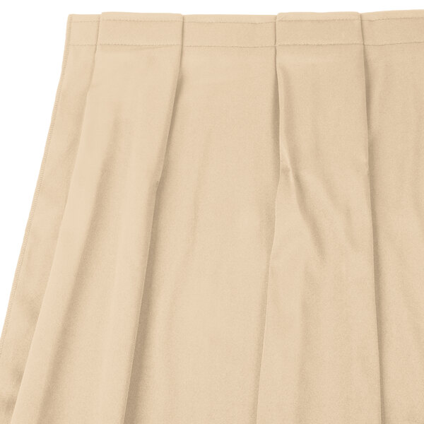 A cream Snap Drape box pleat table skirt with velcro clips.
