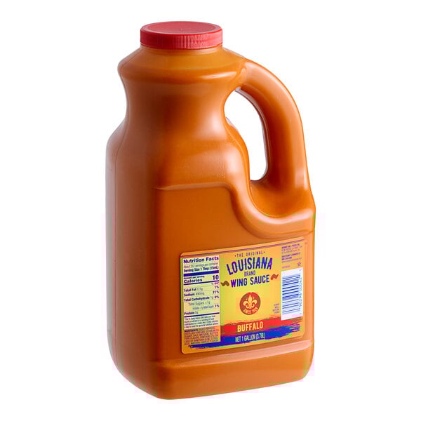 A jug of Louisiana Wildly Wicked Buffalo Wing Sauce with a red lid and label.