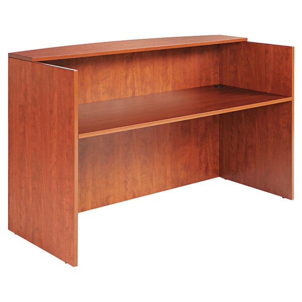 A medium cherry wooden reception desk with a counter shelf.