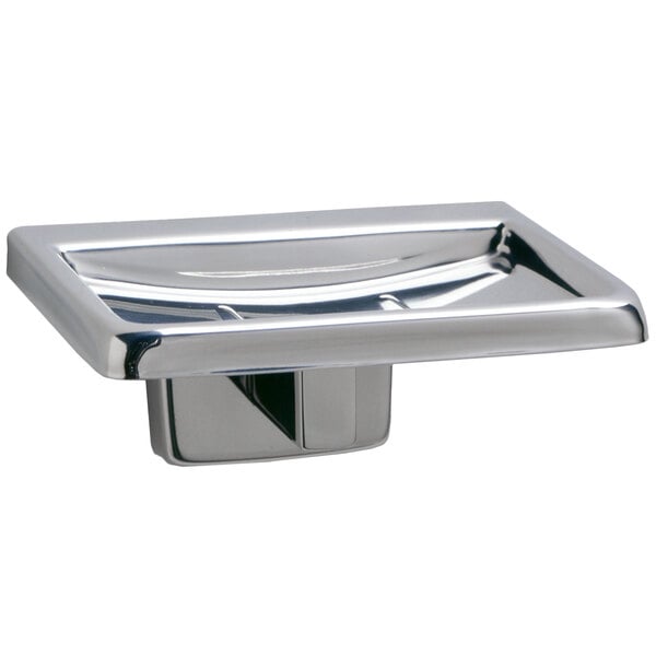 A close-up of a silver Bobrick surface-mounted soap dish with a bright polished finish.