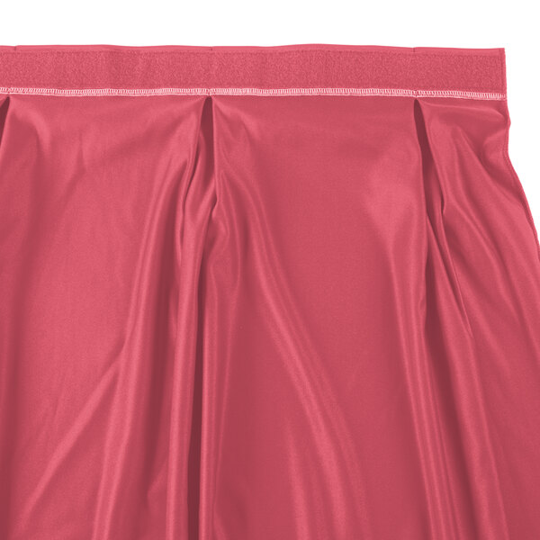 A dusty rose table skirt with a white stripe at the hem.