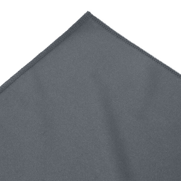 A slate blue Snap Drape table skirt with bow tie pleats and a folded edge.