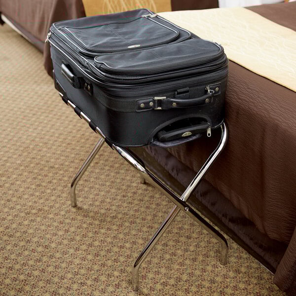 A black suitcase on a CSL chrome metal luggage rack.