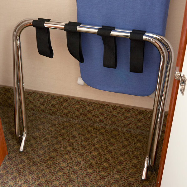 A chrome metal CSL luggage rack with black straps attached.