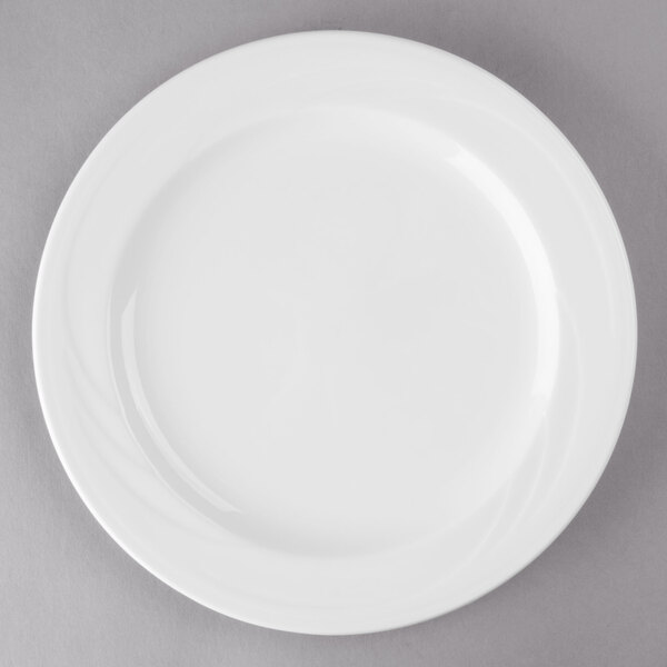 A Libbey white porcelain plate with a white rim on a gray surface.