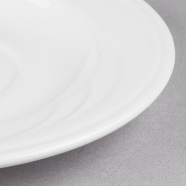 A Libbey white porcelain tea saucer with a white rim.