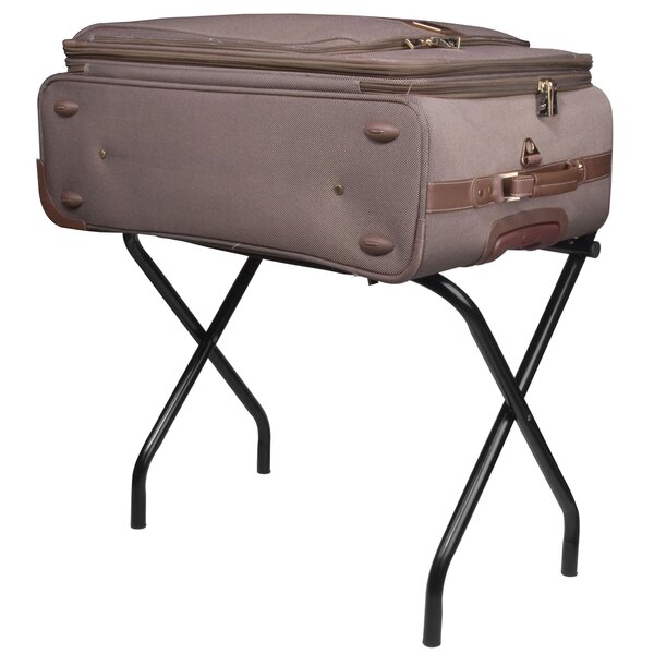 A black metal high back luggage rack with a suitcase on it.