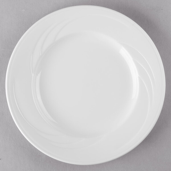 A white Libbey porcelain plate with a wavy design on the rim.