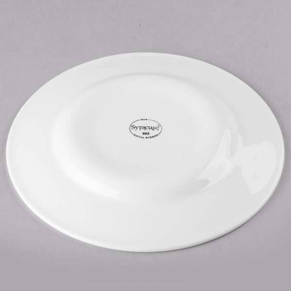 A white Libbey porcelain plate with a wide rim and black writing that says "Royal Rideau" in black.