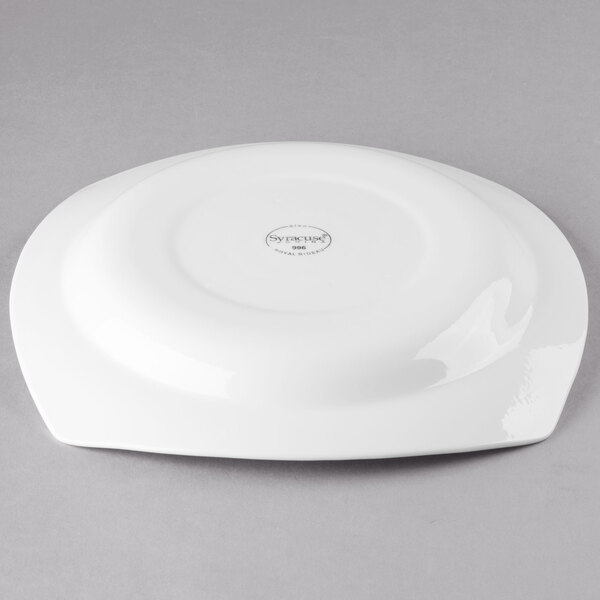 A white square porcelain bowl with a circular design on it.