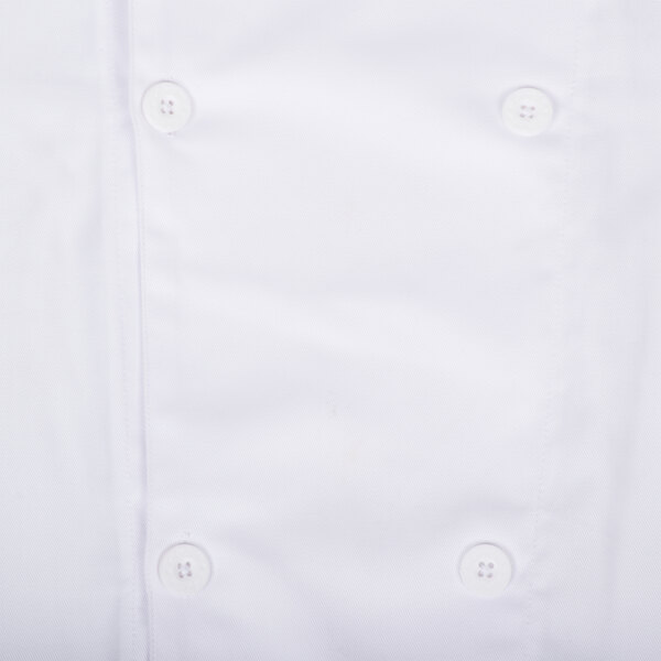 A close up of a white Chef Revival short sleeve chef jacket with buttons.