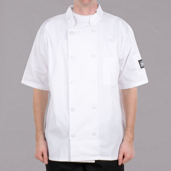 A man wearing a white Chef Revival short sleeve chef coat.