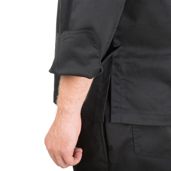 A man wearing a black Chef Revival long sleeve chef jacket with mesh back.