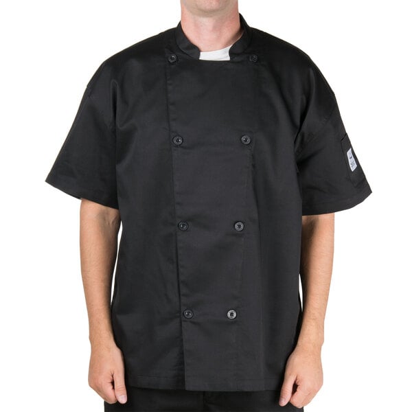 A man wearing a black Chef Revival chef coat with mesh on the back.