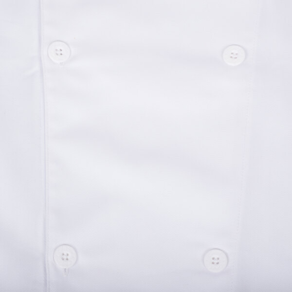 A close up of a white Chef Revival long sleeve chef jacket with a button and mesh back.