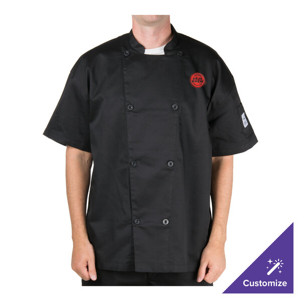 A man wearing a black Chef Revival short sleeve chef jacket with mesh back.