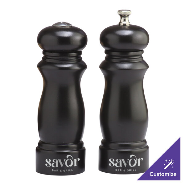 A black Chef Specialties Salem ebony pepper mill and salt shaker set.