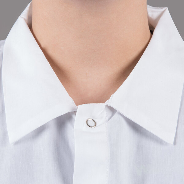 A person wearing a white Chef Revival cook shirt with short sleeves.