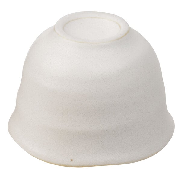 A white stoneware sake cup with a circular top.