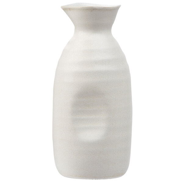 A white stoneware sake bottle with a handle.