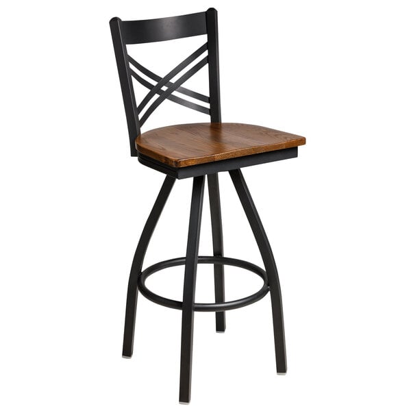 A BFM Seating black steel bar stool with a wooden seat and back.