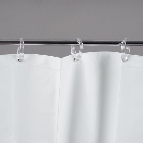 A white Bobrick shower curtain with rings attached.