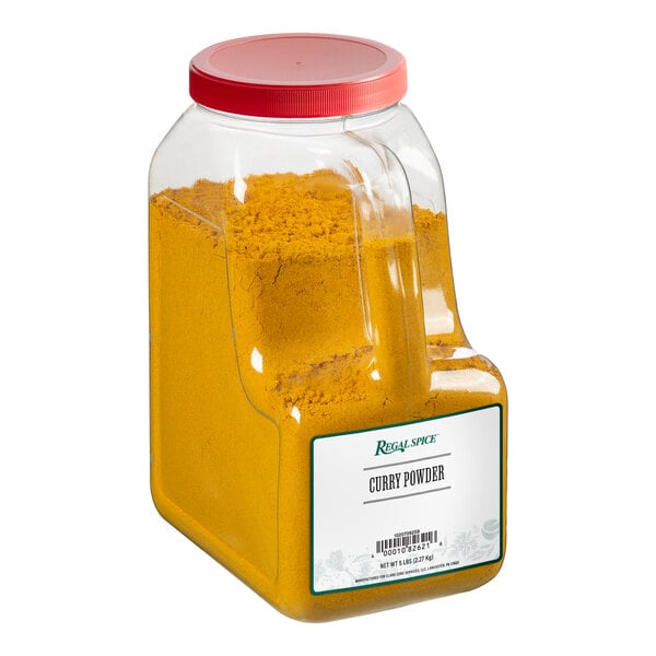 A clear container of yellow Regal curry powder.