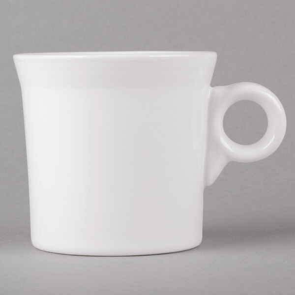 A Fiesta white china mug with a handle.