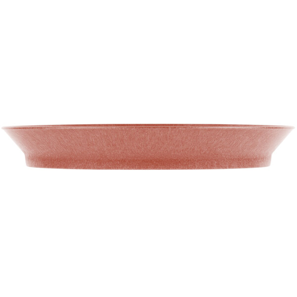 A paprika oval deli server with a white border on a red surface.