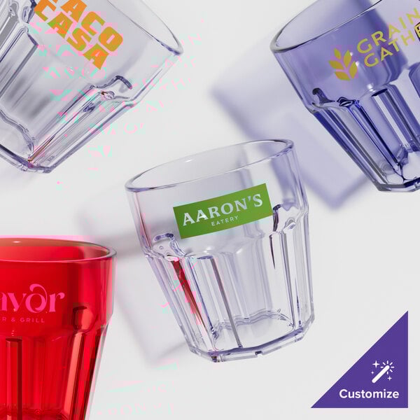 A group of clear GET plastic tumblers with green customizable labels.