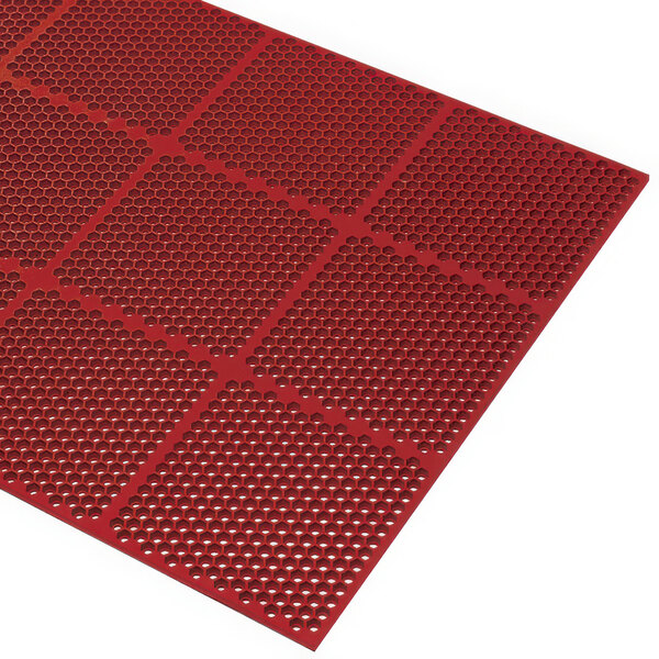 A red Cactus Mat commercial rubber mat with honeycomb holes.