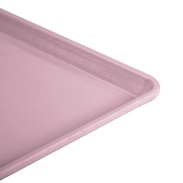 A close-up of a pink Cambro dietary tray.