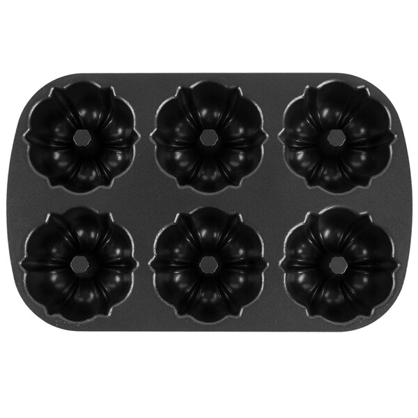 A black Chicago Metallic cake pan with six circular designs.