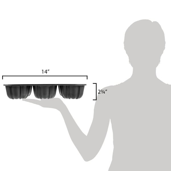 A woman holding a Chicago Metallic mini cake pan filled with mini cakes.