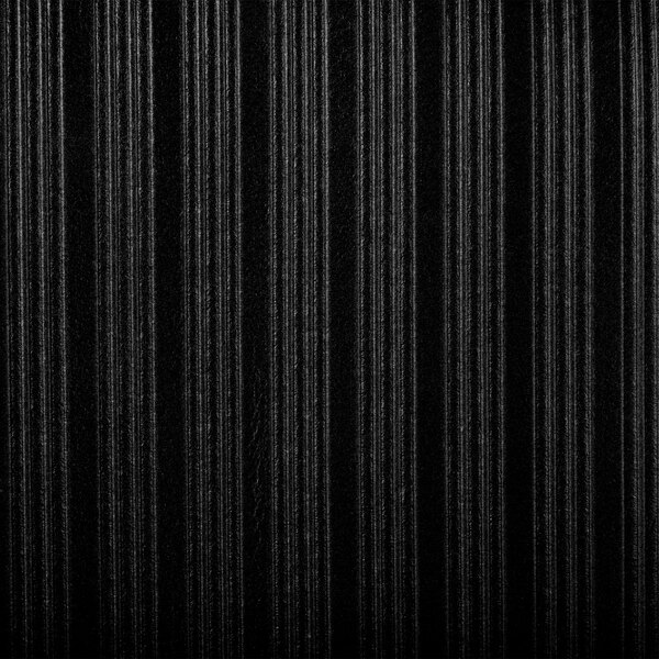 A close-up of a black ribbed surface on a Cactus Mat Tredlite anti-fatigue mat.
