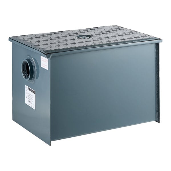 A rectangular metal grease trap with a textured lid and threaded side connection.