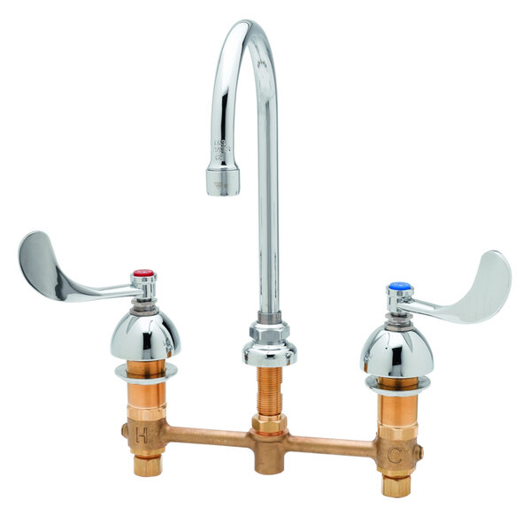 A chrome T&S deck mount faucet with wrist action handles.