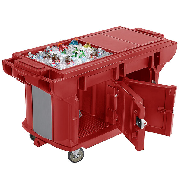 A red plastic container with a large open door on a Cambro Versa Ultra work table.