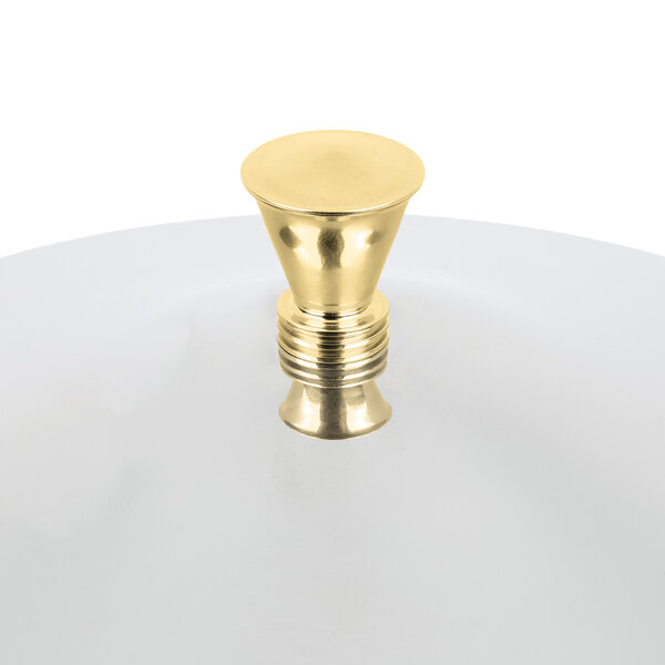 A Vollrath brass and stainless steel cover for a New York 2 Gallon Cold Beverage Dispenser on a white plate.