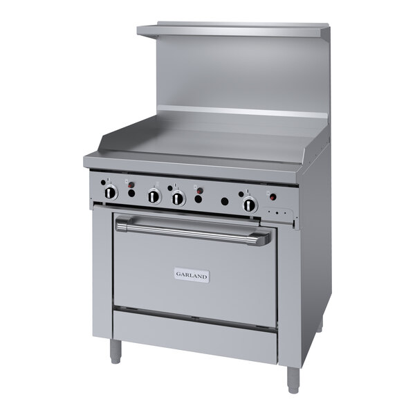 A large stainless steel Garland gas range with griddle and oven.