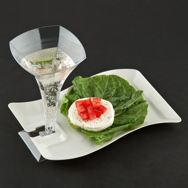 A Fineline ivory plastic cocktail plate with a glass of water and food on it.